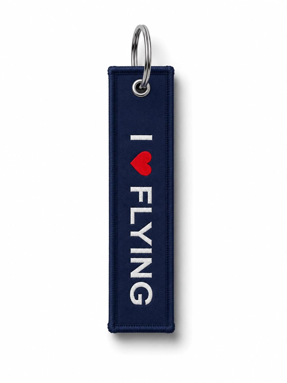 Lacivert kumaş anahtarlık, "I Love Flying" yazılı, pilot temalı aksesuar, anahtarlar için şık ve dayanıklı tasarım.